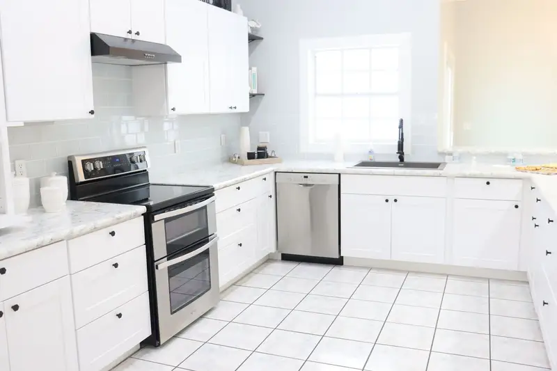 A bright modern kitchen with white cabinets and natural light, the kind of room a listing page leads with